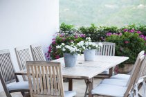Potted flowers on patio table — Stock Photo