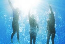 Confident and strong triathletes swimming underwater — Stock Photo