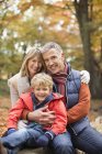 Boy smiling with grandparents in park — Stock Photo