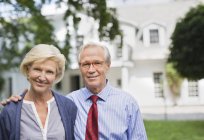 Couple smiling together outside house — Stock Photo