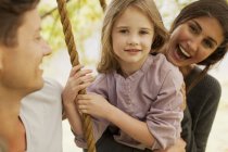 Portrait de famille heureuse sur swing — Photo de stock