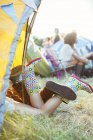 Couple legs sticking out of tent at music festival — Stock Photo