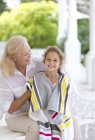 Caucasian old woman wrapping granddaughter in towel — Stock Photo
