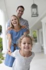 Young family playing together on porch — Stock Photo