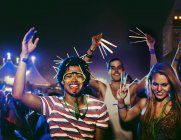 Fans with glow sticks cheering at music festival — Stock Photo