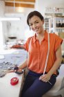 Dressmaker cutting fabric in studio — Stock Photo
