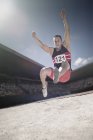 Long jumper above sand pit — Stock Photo
