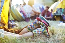 Couples jambes qui sortent de la tente au festival de musique — Photo de stock