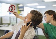 Empresária que não mostra sinal de celular para colega — Fotografia de Stock