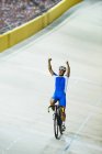 Track cyclist celebrating in velodrome — Stock Photo