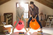 Couple jumping on exercise balls together — Stock Photo