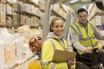 Workers smiling in warehouse — Stock Photo