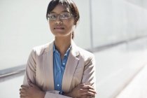 Businesswoman standing with arms crossed — Stock Photo