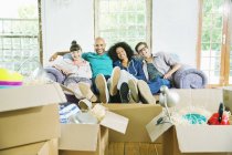 Friends relaxing together in new home — Stock Photo