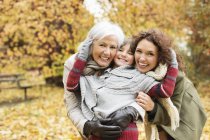 Three generations of women smiling in park — Stock Photo