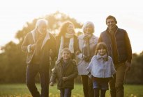 Family walking together in park — Stock Photo