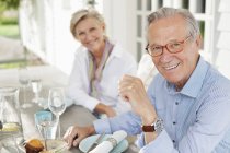 Couple smiling at table together — Stock Photo