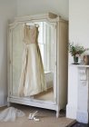 Wedding gown hanging from wardrobe — Stock Photo