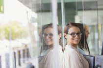 Businesswoman standing in modern office building — Stock Photo
