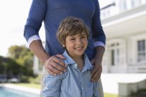 Father and son standing outdoors — Stock Photo