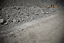 Digger driving in quarry during daytime — Stock Photo