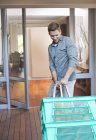 Man making deliveries on front porch — Stock Photo