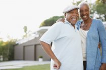Older couple laughing together outdoors — Stock Photo