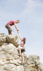 Side view of climbers scaling steep rock face — Stock Photo