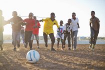 African boys  playing soccer together in dirt field — Stock Photo