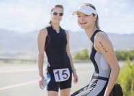 Runners smiling together outdoors — Stock Photo