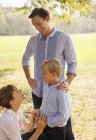 Family relaxing together in park — Stock Photo