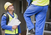 Skillful caucasian workers talking on site — Stock Photo