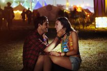 Affectionate couple outside music festival — Stock Photo