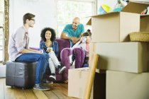Friends relaxing together in new home — Stock Photo