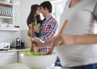 Father and daughter touching noses in kitchen — Stock Photo