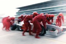 Racing team working at pit stop — Stock Photo