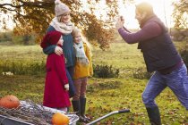 Father taking picture of family at countryside — Stock Photo