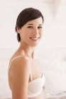 Portrait of smiling woman in bra — Stock Photo