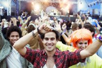 Portrait of fans dancing and cheering at music festival — Stock Photo