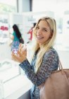 Woman trying on perfume in drugstore — Stock Photo