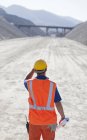 Worker standing on road in quarry — Stock Photo