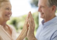 Seniorenpaar berührt Hände auf Terrasse — Stockfoto
