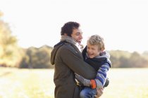 Happy father and son playing outdoors — Stock Photo