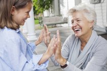 Woman and granddaughter playing clapping game — Stock Photo