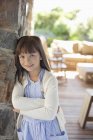 Girl leaning against stone wall — Stock Photo