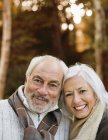 Older couple smiling together in park — Stock Photo