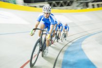 Track cyclist racing in velodrome — Stock Photo