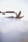 Woman feet resting on convertible — Stock Photo