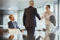 Business people shaking hands in office building — Stock Photo