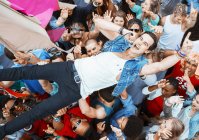 Performer singing and crowd surfing at music festival — Stock Photo
